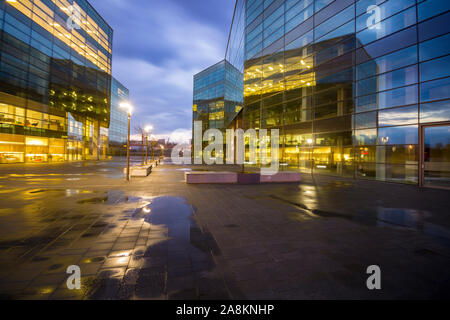 Office building with glass facade,Modern office building in the evening Stock Photo