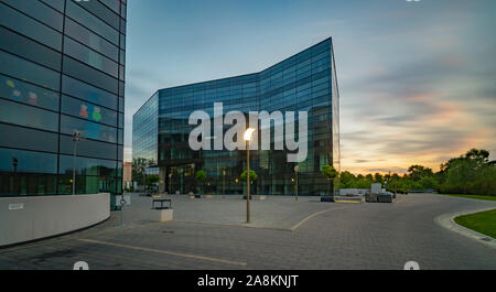 Office building with glass facade,Modern office building in the evening Stock Photo
