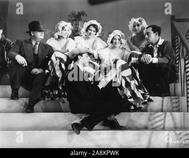 Director EDWARD SEDGWICK and Chorus Girls watching AL HIRSCHFELD drawing BUSTER KEATON on set during filming of FREE AND EASY 1930 Metro Goldwyn Mayer Stock Photo