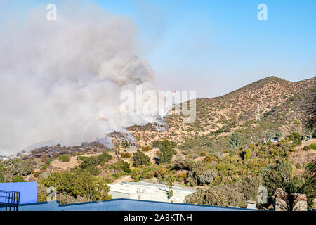 Wildfire on hillside with helicopters dropping water, Barham Fire November 9, 2019 Stock Photo