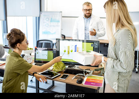 Group of diverse people working on the packaging design of a new eco product in the office. Branding and marketing of new trendy foods concept Stock Photo