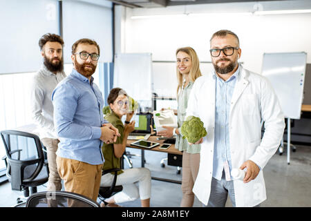 Portrait of a team working on the packaging design of a new eco product in the office. Branding and marketing of new trendy foods concept Stock Photo