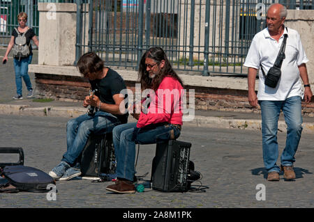 Street musicians playing electric guitar in city centre of Rome, Lazio, Italy Stock Photo