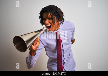 Young african american businessman screaming using vintage megaphone Stock Photo