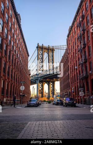 View from Main Street to Manhattan Bridge and Empire State Building, at sunrise, blue hour, Dumbo, Brooklyn, New York, USA Stock Photo