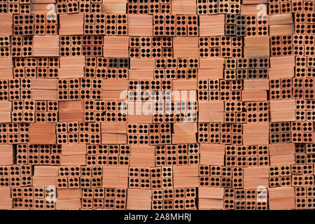 Red Clay or Terracotta bricks stacked neatly on a building site Stock Photo