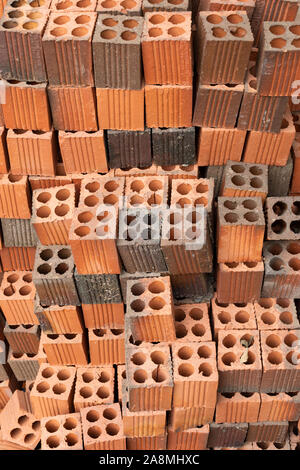 Red Clay or Terracotta bricks stacked neatly on a building site Stock Photo