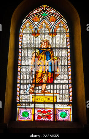 coloured stained glass window colored in a dark background church with Zerubbabel bible character Stock Photo