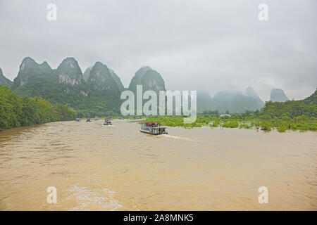 Editorial: GUILIN, GUANGXI, CHINA, April 19, 2019 - Passing Maozhou island in convoy in the vicinity of Lingchuan near Guilin Stock Photo