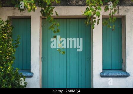 Closed wooden shutters on the windows and doors of the Mediterranean authentic home Stock Photo