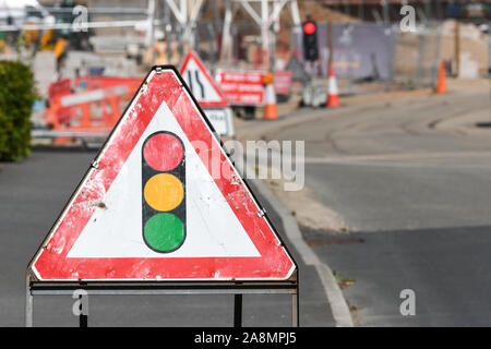 Roadworks signs and temporary traffic lights Stock Photo - Alamy