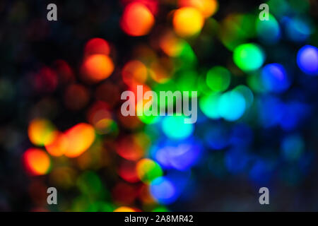 Blurred defocused multi color lights as Christmas decorations background. Party concept. Stock Photo