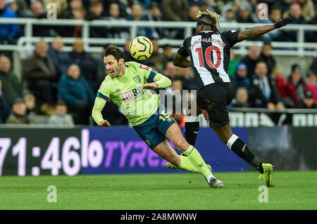 9th November 2019, St. James's Park, Newcastle, England; Premier League, Newcastle United v Bournemouth : Allan Saint-Maximin (10) of Newcastle United beats Adam Smith (15) of Bournemouth to the ball Credit: Iam Burn/News Images Stock Photo