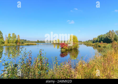 Autumnal view to a small reservoir of the Wertach river near Bobingen in bavaria Stock Photo