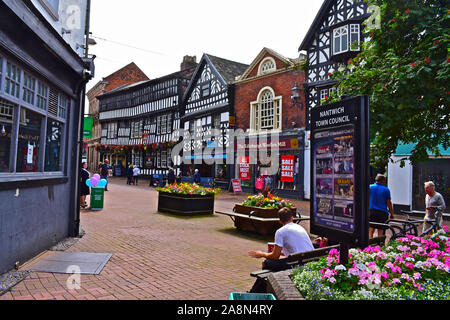 A view of the ancient half-timbered buildings in the High Street of Nantwich with the 16th Century Crown Inn in the centre distance. Stock Photo