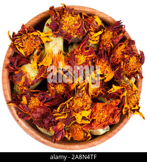 Dried Marigold flowers in a small wooden bow isolated on white, close-up. Stock Photo