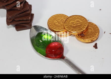 Kids favorite jelly chocolate over a spoon And gold chocolates Stock Photo