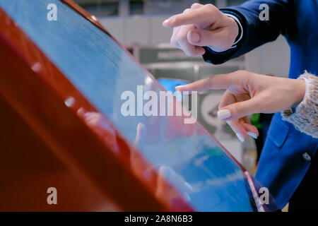 Woman and man using interactive touchscreen display at technology exhibition Stock Photo