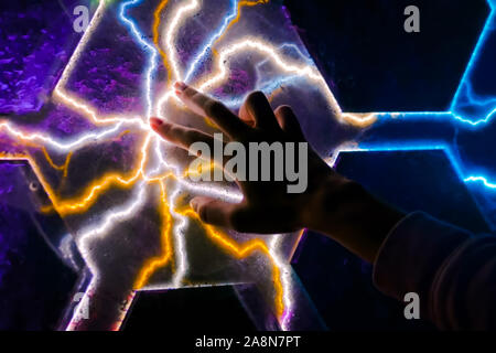 Woman touching plasma panel display Stock Photo