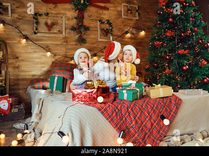 Mother and children with gifts in the house for Christmas Stock Photo