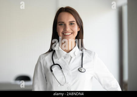 Portrait of smiling female doctor posing wearing whites Stock Photo