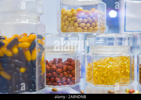 Supplements and pills in clear glass bottle for sale at pharmacy drug store Stock Photo