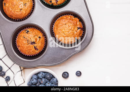 Delicious muffins with blueberries in a tray on the white wooden table Stock Photo