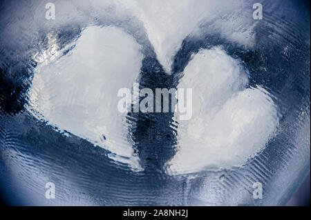 Two heart symbols embedded in a block of ice Stock Photo