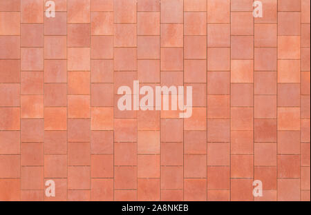 Front view of a wall made of rusty square shaped tiles or slabs. High resolution full frame textured background. Stock Photo