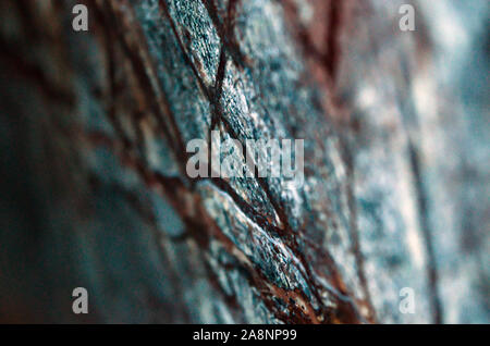 Close piece of textured marble with brown and black fibers on gray background with blure. Stock Photo