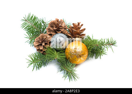 Pine cone with bauble and evergreen branch on a white background. Christmas decoration Stock Photo