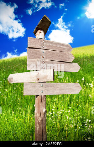directional wooden arrows on nature background Stock Photo
