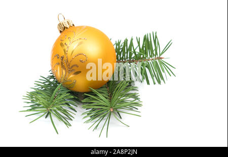 Christmas decoration yellow ball bauble with branches of fir tree on white background Stock Photo