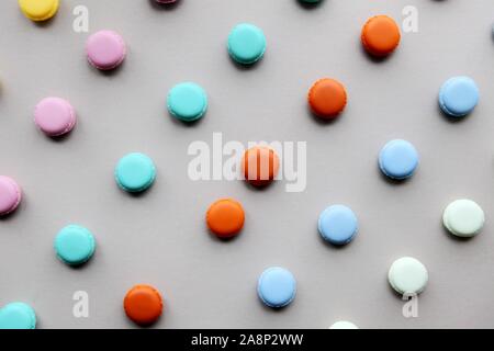 Colorful natural macarons cake, top view flat lay, sweet macaroon on gray background. Minimal concepts macaroons pattern above, food background Stock Photo