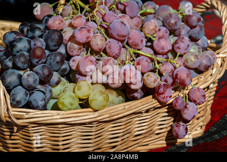 White, black and red grapes in a basket; Stock Photo