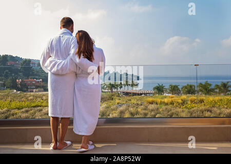 Couple enjoying morning on their terrace with sea view. Stock Photo