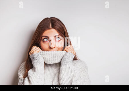 Portrait of a happy young woman in warm cozy sweater. Stock Photo