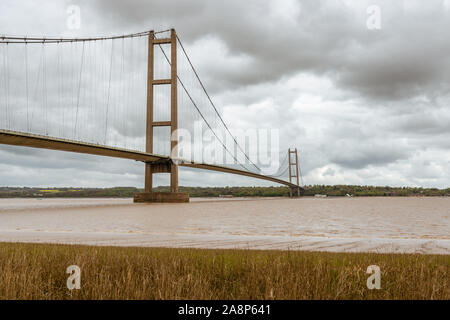 Grey clouds over the Humber Bridge, seen from Barton-Upon-Humber in North Lincolnshire, England, UK Stock Photo