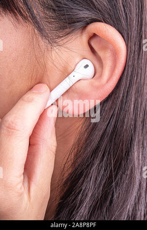 Female wearing earphones headphones Stock Photo
