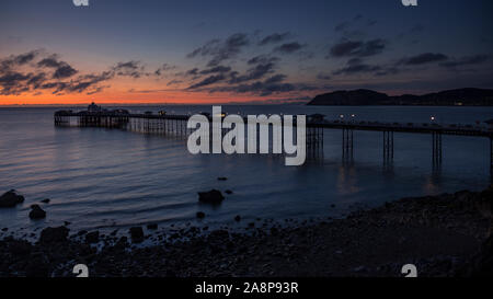 Dawn over the Victorian pier at Llandudno on the North Wales coast Stock Photo