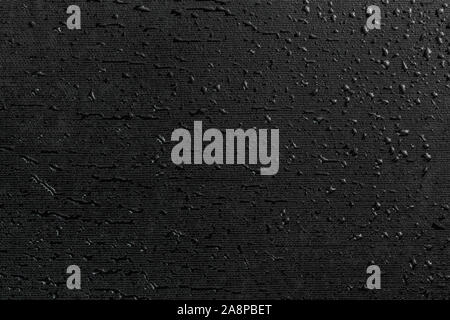 water drops on black flat rubber surface dark macro background Stock Photo