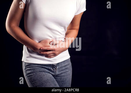 Woman feels strong stomach or period pain. People, healthcare and medicine concept Stock Photo