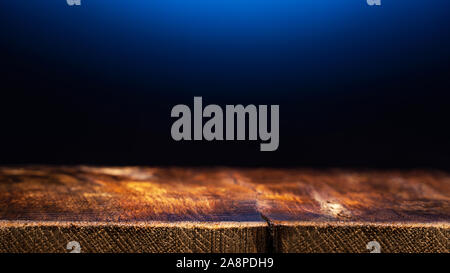 Empty Wooden Table on Dark Blue Background. Backdrop for Product Placement Stock Photo