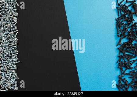 Flat Lay Composition With Different Screws on Black and Blue Background. Top View of Checklist Concept Stock Photo