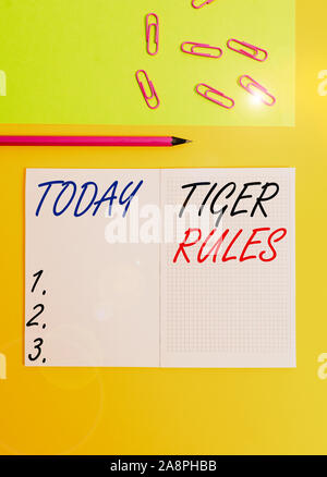 Handwriting text writing Tiger Rules. Conceptual photo Willpower and demonstratingal strength Resistance to imperial rule Blank squared notebook penci Stock Photo