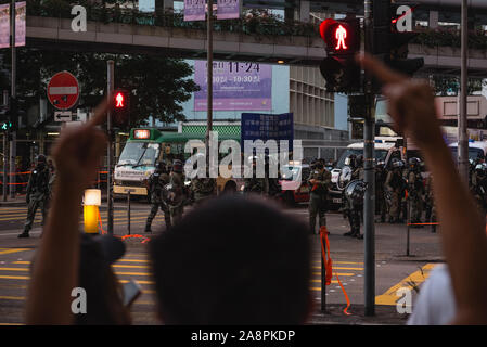 A protester gestures at the riot police during an anti-fascist counter ...