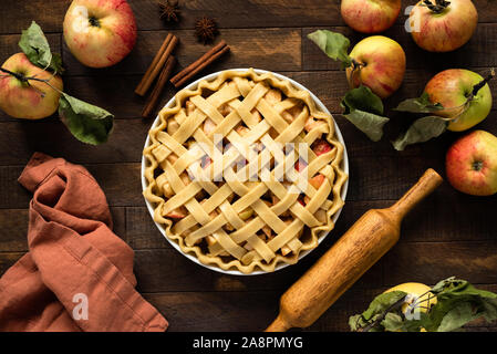 Apple pie with lattice top on wooden background, table top view. Rustic american apple pie Stock Photo