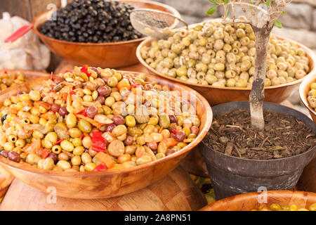 Marinated olives and garlic on the counter in the market - Luberon, Provence, France Stock Photo