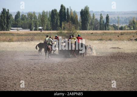 Riders playing traditional buzashi with a goat carcass in Kyrgyzstan Stock Photo