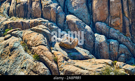 Unusual natural rock formation sitting on larger boulders Stock Photo